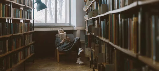 A woman reading a book at library